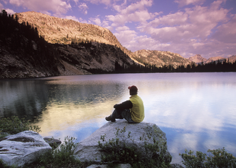 Man sitting on a large rock. 