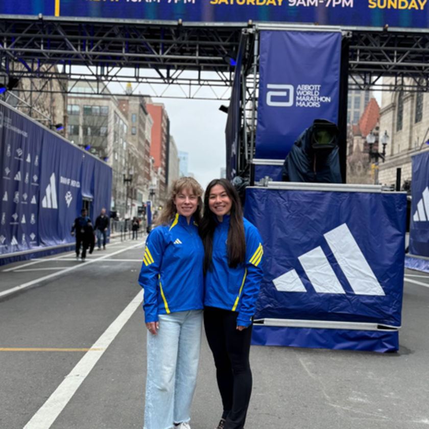two women standing at the Boston Marathon finish line.
