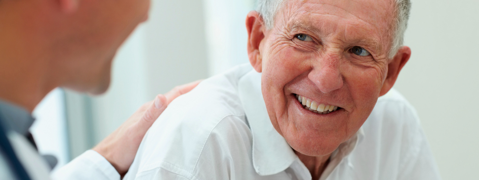 Older man having a casual talk with a doctor