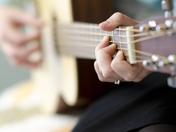 teen playing guitar