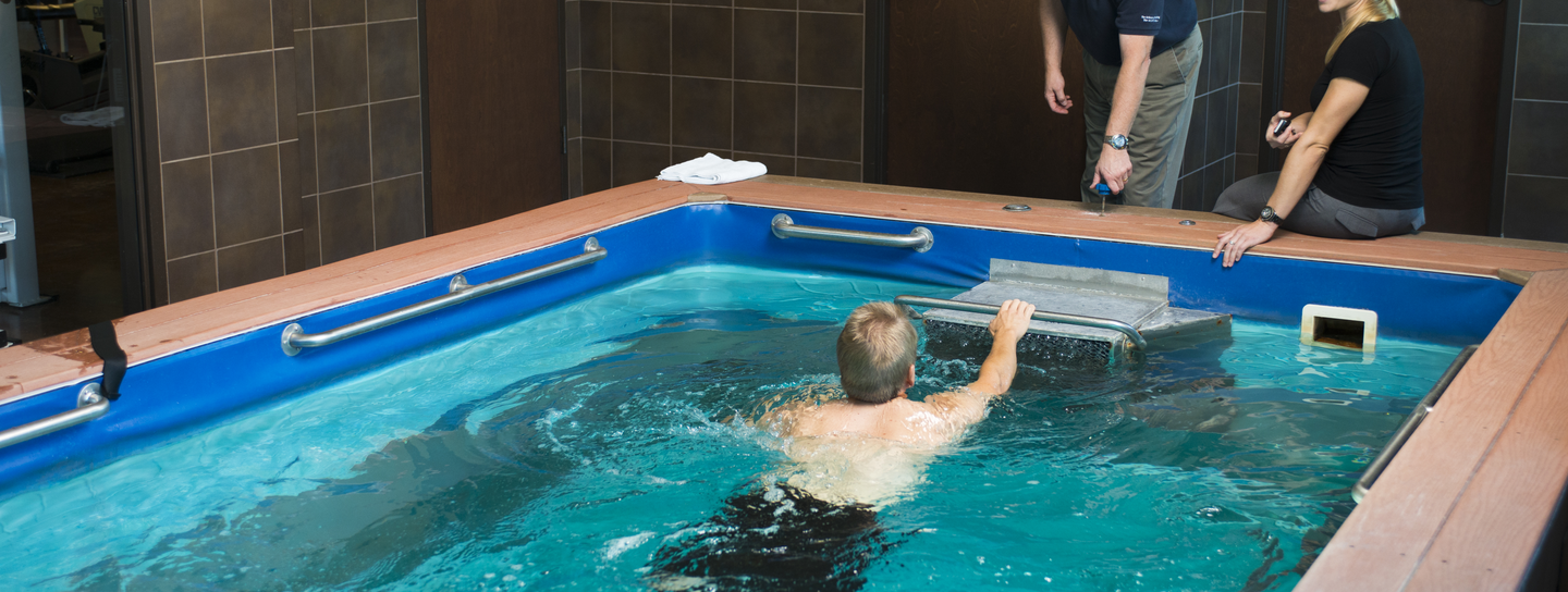 Person swimming toward therapists