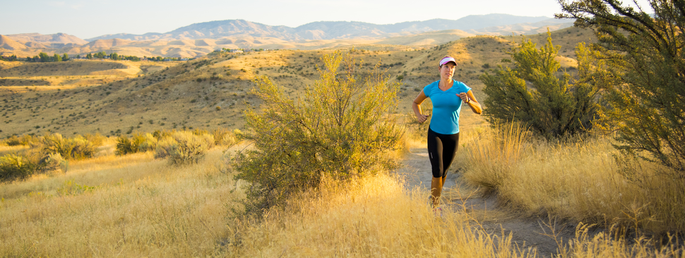 Woman runs through the scenic hills of Boise, Idaho.