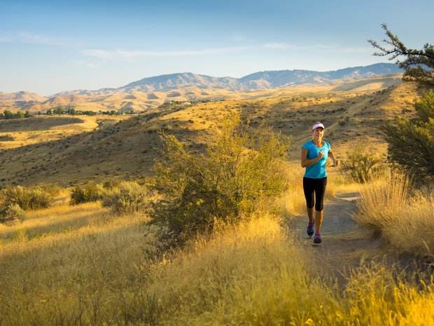 Woman running in a field.