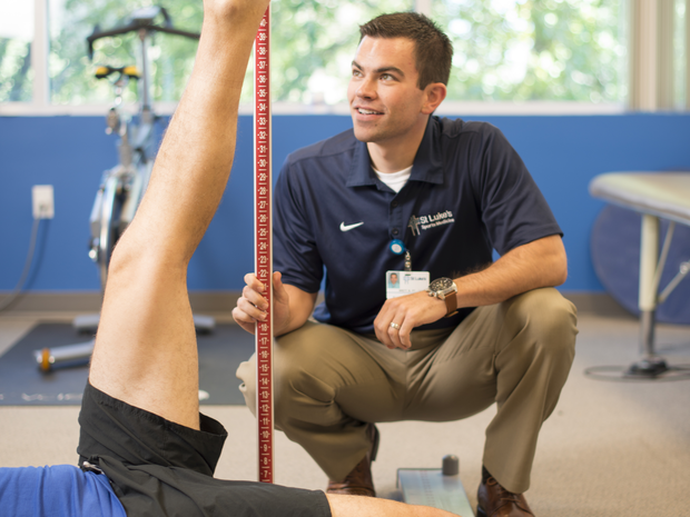 physical therapist working with an athlete