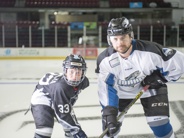 Local team players pose on the ice.