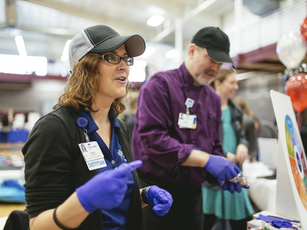 provider with a community member at a health fair