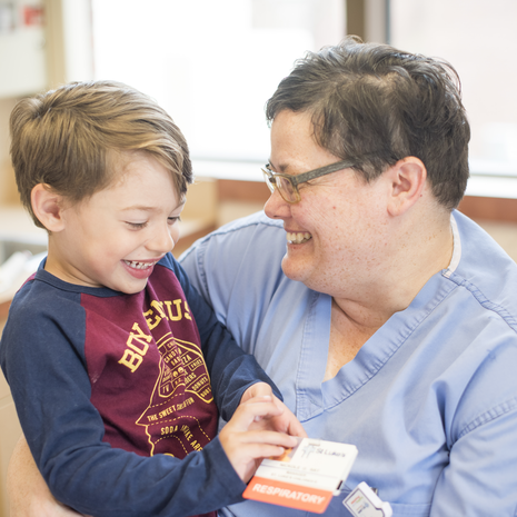 Child smiles with medical professional