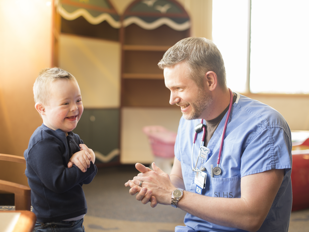A St. Luke's Children's patient playing with a clinician at St. Luke's Children's facility.