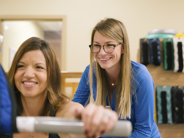 Physical therapist works with patient