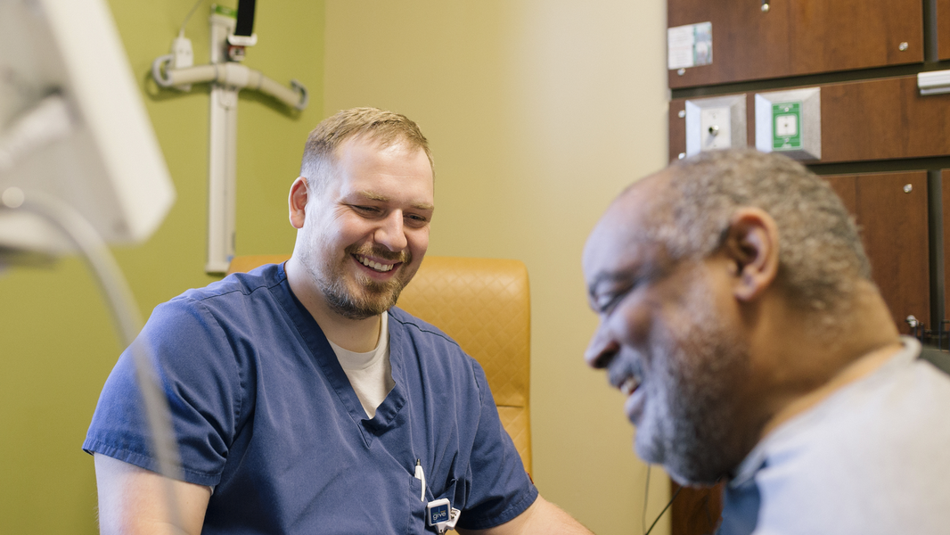 Rehabilitation employee and patient sharing a laugh.