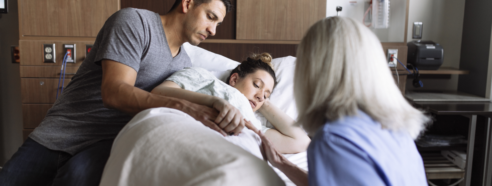 A pregnant woman holding her belly.