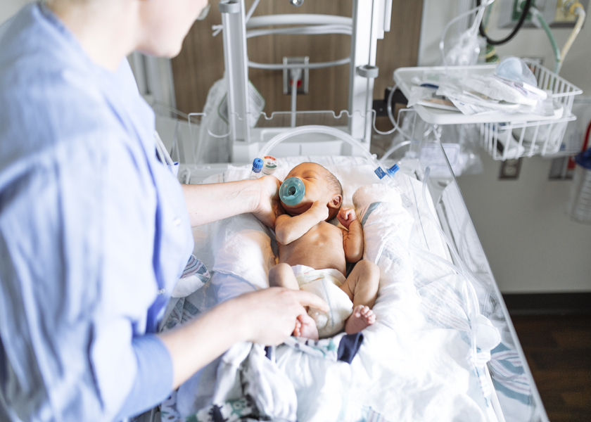 A nurse helps a newborn baby