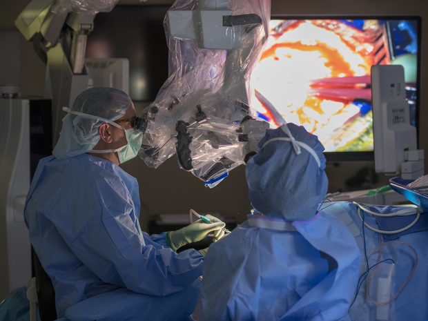 A doctor performs neurosurgery