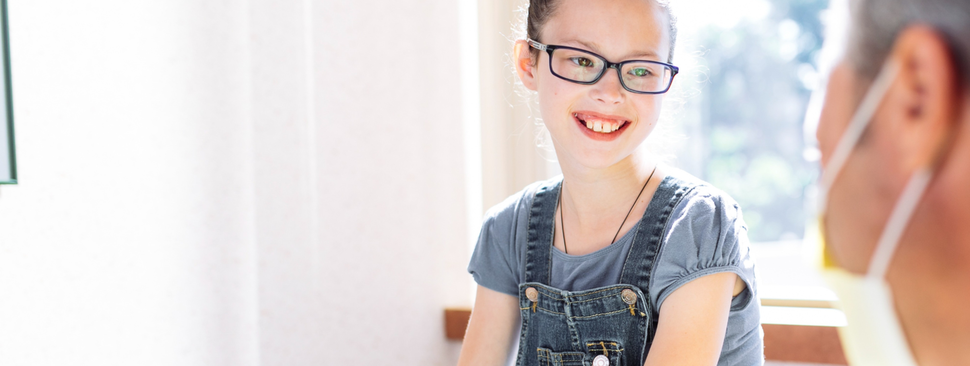Girl smiles at doctor