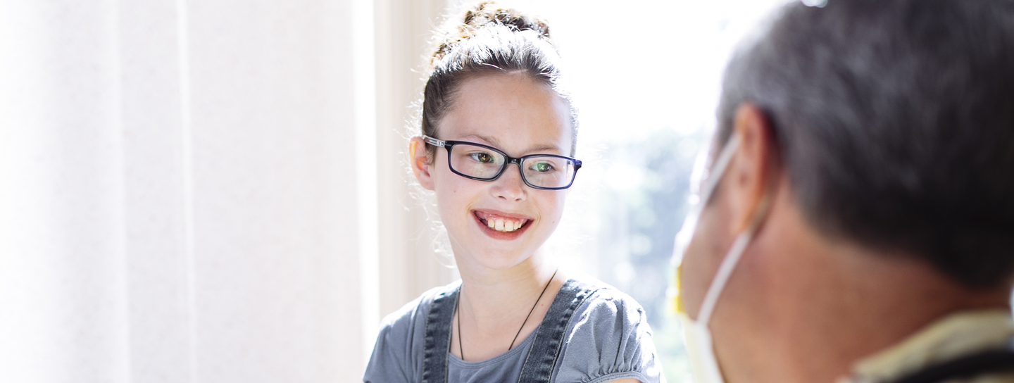 Girl smiles at doctor