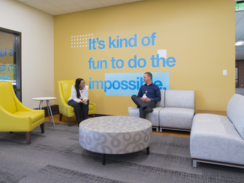 Staff members having discussion in lobby.