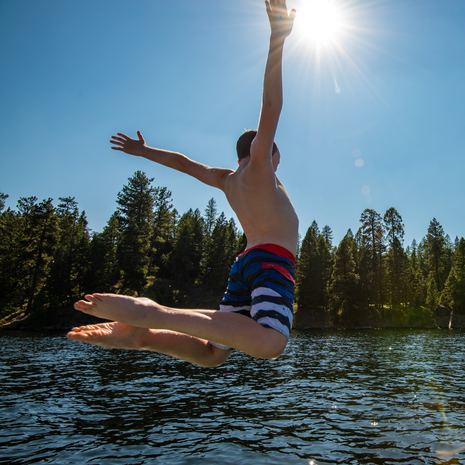 A boy jumps into Payette Lake in McCall