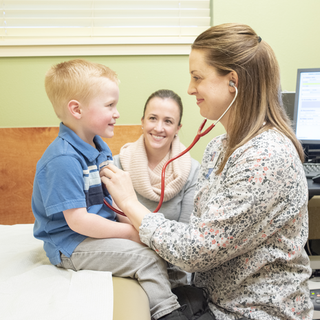 St. Luke's RN listens to a young patient's heart