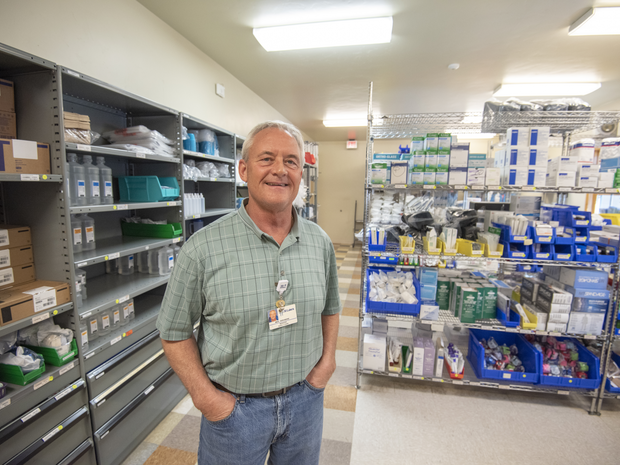 Volunteer smiles while working at St. Luke's