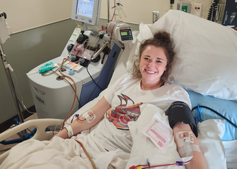 Lexi in hospital bed while donating stem cells.
