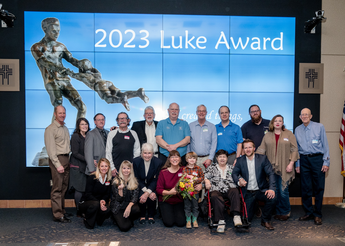 Large group of people in front of video bank