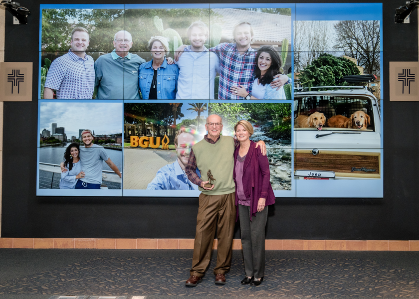 Man and woman stand in fromt of video bank