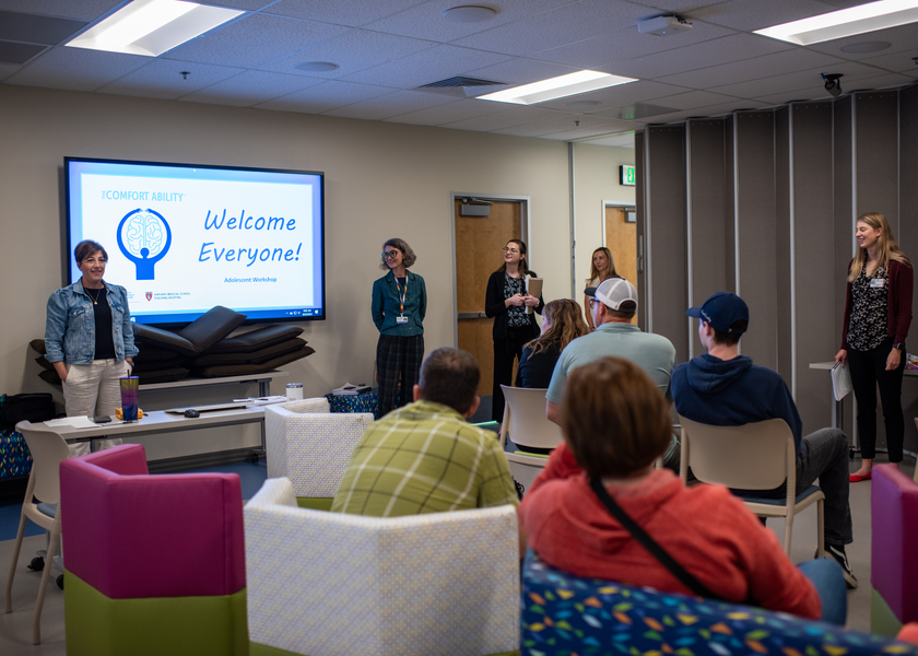 Standing woman speaks to audience