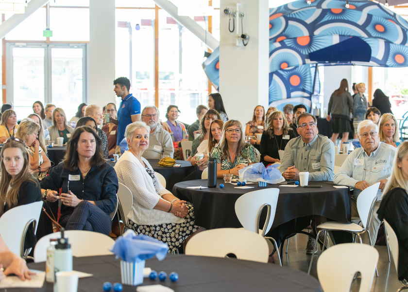 Attendees listen to a speaker at the celebration