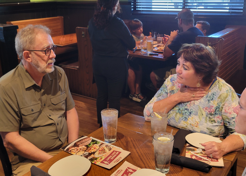 Sharon and Reuben talk at the restaurant