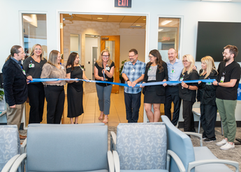 Ribbon cutting event at the opening of the new location.