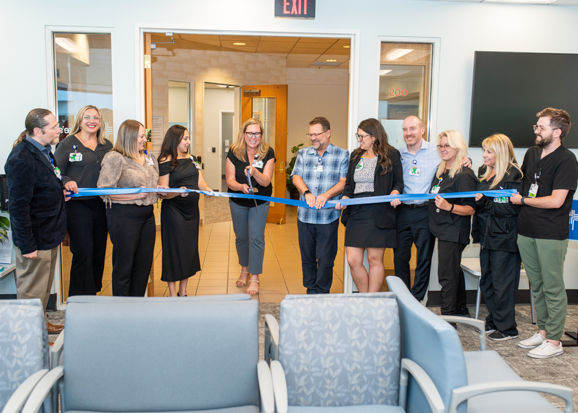 Ribbon cutting event at the opening of the new location.