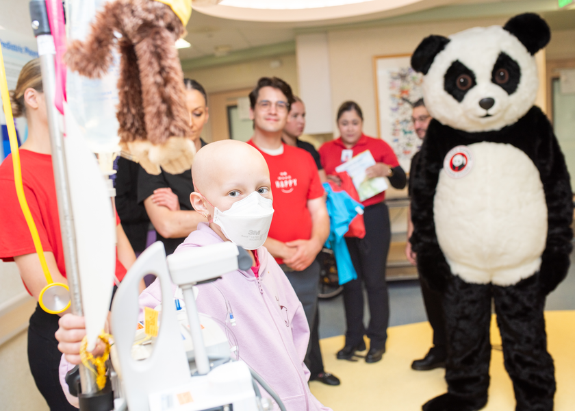A patient celebrates with St. Luke's and Panda Express team members.