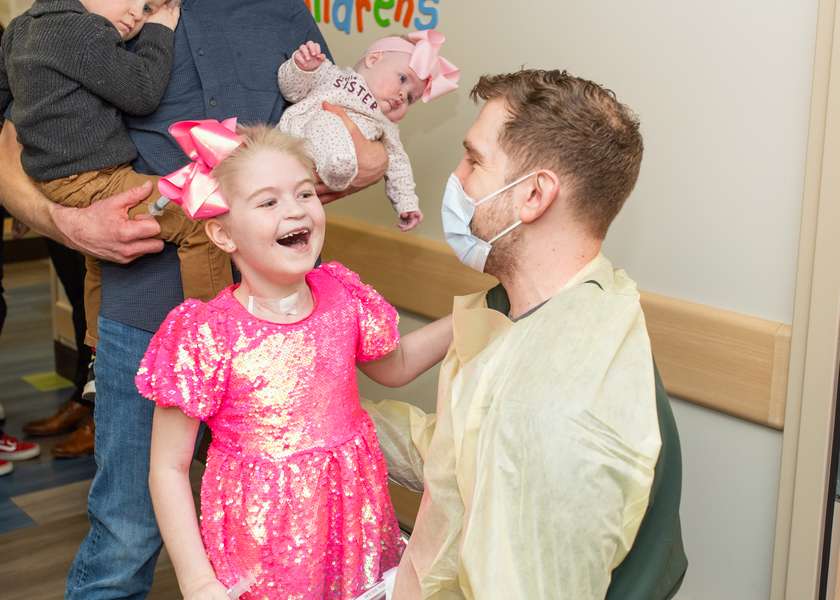 Little girl hugs nurse who took care of her.