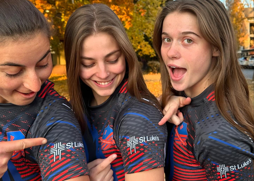 Boise State rugby players pointing to St. Luke's logo on their jerseys.