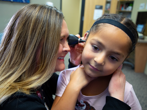 A child getting her ears checked