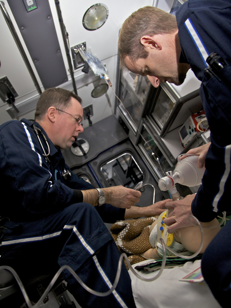Two paramedics work on patient in Air St. Luke's vehicle.