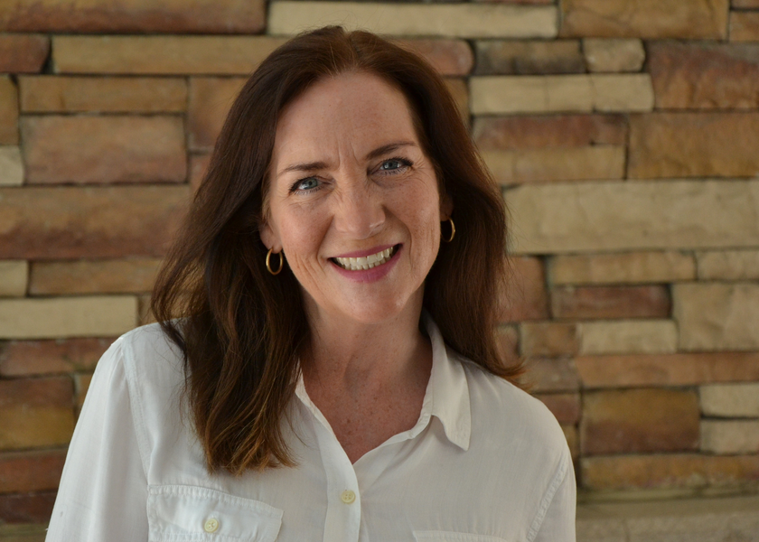  Woman with brown hair smiles at camera