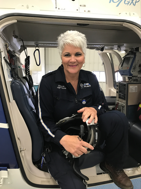  Woman sitting in cocopit of helicopeter