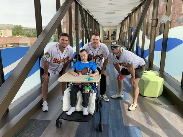 After missing game, young fan gets visit from Boise Hawks at St. Luke’s Children’s Hospital