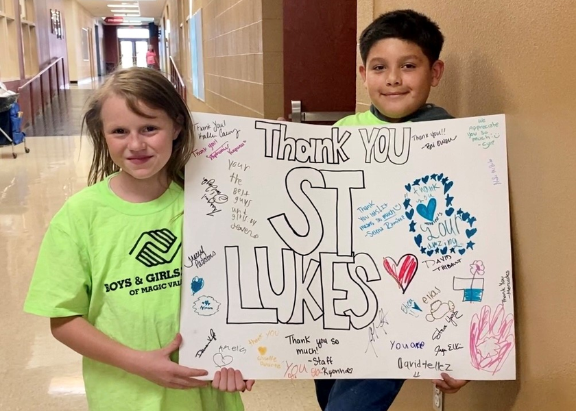 Kids from the Boys and Girls Club with a thank you sign.