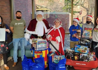 Mr. and Mrs. Santa Claus along with a collection of donations.