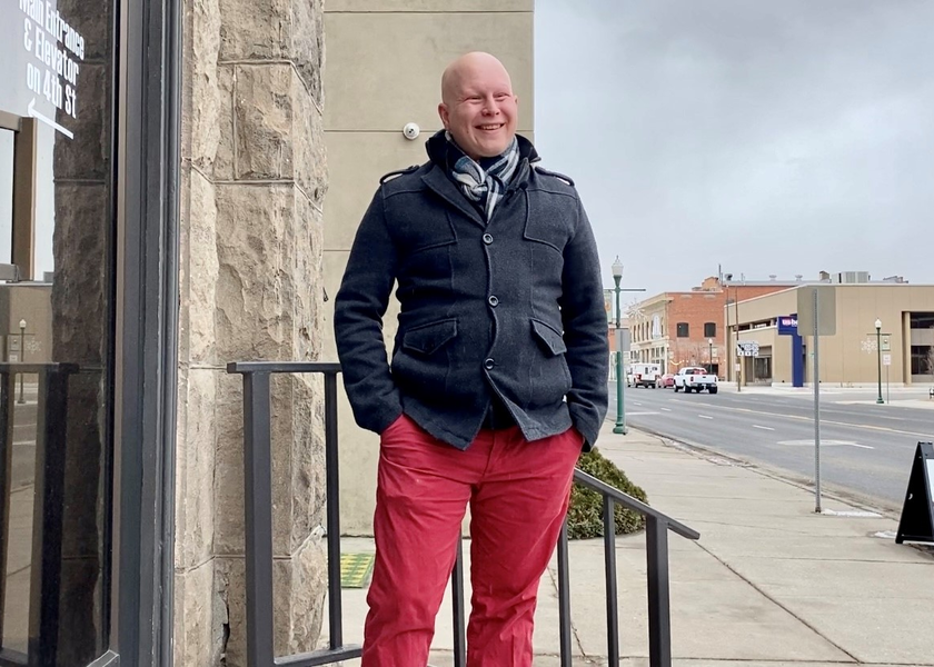  Man stands outside building