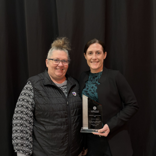 Two women posing for a picture.