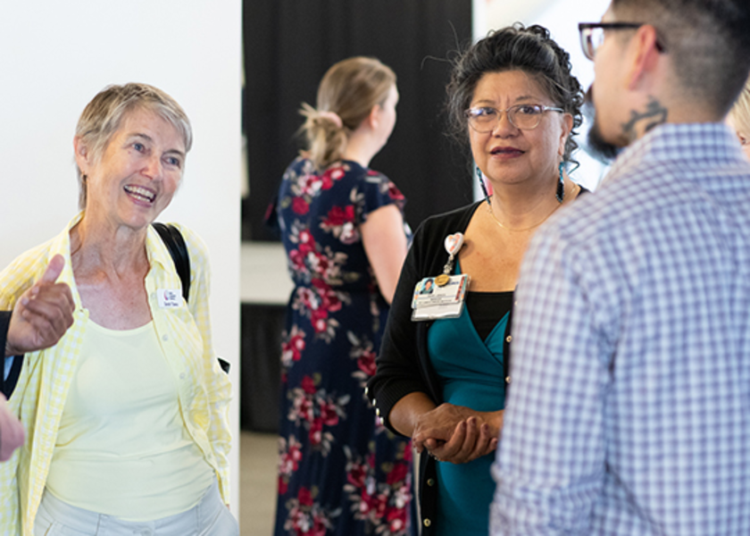 Healthcare professionals standing in a circle, actively engaged in conversation