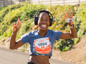 Woman smiling as she runs the FitOne half marathon