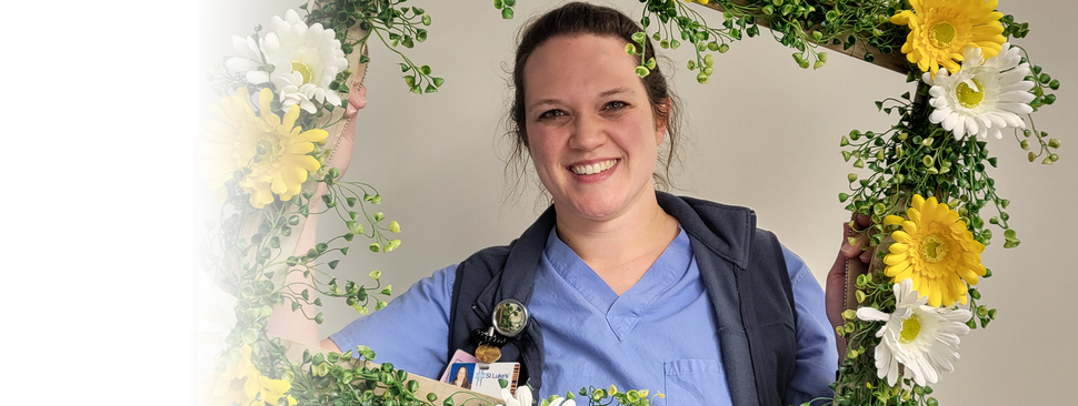 Daisy Award winner holding a frame of flowers