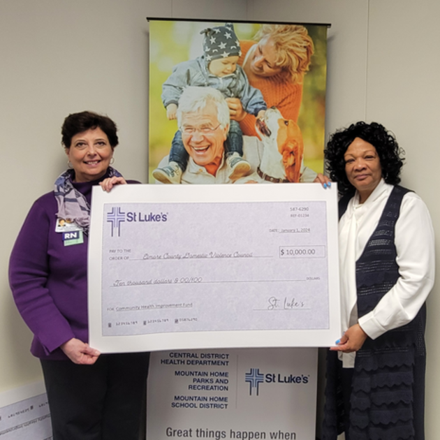 St. Luke's Elmore COO/CNO presenting a check to a representative for the Elmore County Domestic Violence Council.