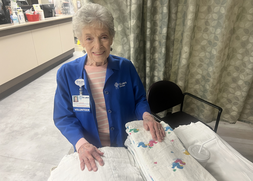 Edith Molnar, a St. Luke's volunteer in the Meridian NICU, folds blankets for babies.