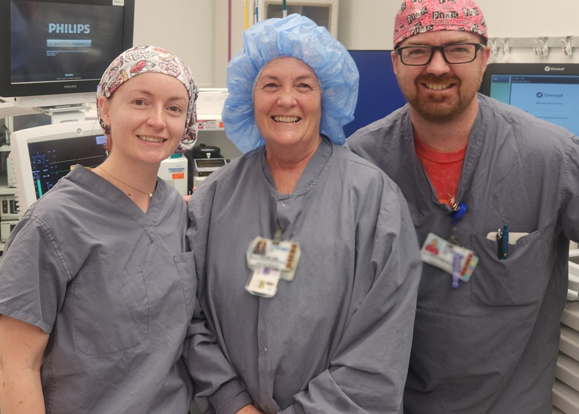 Adult Daughter and Son stand in St. Luke's operating room with their mother.
