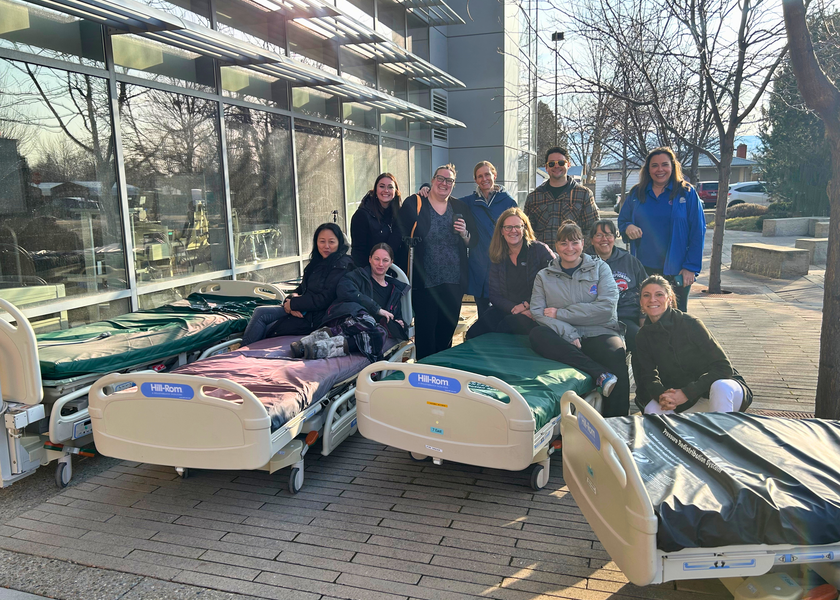 Group of people sit on hospital beds